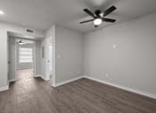 Thumbnail 67 of 79 - Photo of renovated bedroom with ceiling fan and vinyl flooring at Sunset Heights, San Antonio