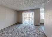 Thumbnail 35 of 47 - A room with a carpeted floor and a sliding glass door.