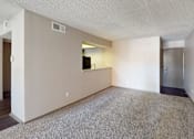 Thumbnail 31 of 47 - A spacious living room with a flat screen TV and a door leading to a kitchen.