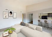 Thumbnail 8 of 47 - A living room with a white couch, a coffee table with a book and a plant on it, and a wall with three framed pictures.
