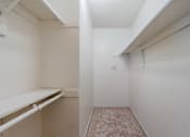 Thumbnail 9 of 20 - A white room with a carpeted floor and a white shelf.