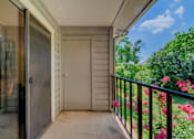 Thumbnail 11 of 20 - A balcony with a glass door leading to a garden.