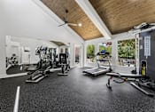Thumbnail 14 of 20 - Spacious fitness center with cardio and strength equipment at Knoll Crest Apartments, San Antonio