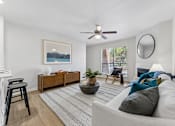 Thumbnail 4 of 20 - Living room with modern furniture and ceiling fan at Knoll Crest Apartments, San Antonio, 78240