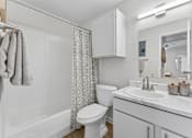 Thumbnail 10 of 20 - Bathroom with white vanity and marble countertop at Knoll Crest Apartments, San Antonio