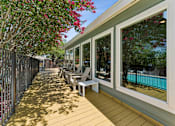 Thumbnail 17 of 20 - Covered outdoor deck with seating and pool view at Knoll Crest Apartments, Texas
