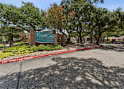 Thumbnail 20 of 20 - Property entrance sign with landscaping and trees at Knoll Crest Apartments, San Antonio, TX 78240