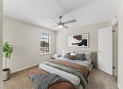 Thumbnail 40 of 47 - a bedroom with a bed and a ceiling fan at The Hudson, North Richland Hills, Texas