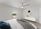 Thumbnail 6 of 50 - a bedroom with a large bed and a ceiling fan at The Hills at Ironhorse, North Richland Hills