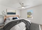 Thumbnail 5 of 50 - a bedroom with a large bed and a ceiling fan at The Hills at Ironhorse, North Richland Hills, 76180