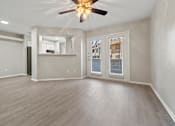Thumbnail 27 of 38 - an empty living room with a ceiling fan at Polo Clubs Apartments, Texas