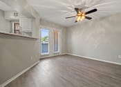Thumbnail 22 of 38 - an empty living room with a ceiling fan at Polo Clubs Apartments, Austin, TX 78729