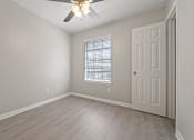 Thumbnail 17 of 38 - an empty bedroom with a ceiling fan and a door at Polo Clubs Apartments, Austin
