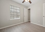 Thumbnail 31 of 38 - bedroom with a door and a window at Polo Clubs Apartments, Austin, Texas