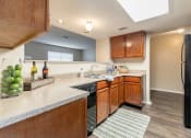 Thumbnail 15 of 21 - Wooden cabinets in kitchen and appliances at Amberly Village Townhomes, Texas