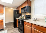 Thumbnail 13 of 21 - Wooden cabinets at Amberly Village Townhomes, Garland, Texas