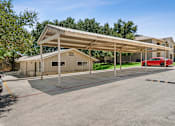 Thumbnail 40 of 40 - parking lot with a covered parking  at Crosspoint Oaks at Boerne, Boerne, TX