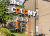 Thumbnail 1 of 27 - Monument sign with modern orange framework and flower bed at The Colony Apartments, Texas