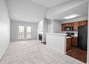 Thumbnail 30 of 38 - A spacious living room with a kitchenette and a fireplace. at Preston Bend, Dallas, TX, 75252