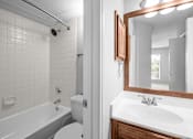 Thumbnail 36 of 38 - A white bathroom with a white toilet, white sink, and a white bathtub. at Preston Bend, Dallas