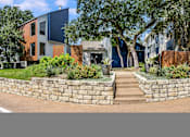 Thumbnail 1 of 15 - a retaining wall with stairs in front of a house at Peaks at Northwest Hills Apartments, Austin, TX