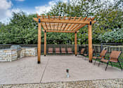 Thumbnail 5 of 24 - a patio with a wooden pavilion and benches at The Broadwater at Salado Creek, San Antonio, TX, 78216