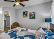 Thumbnail 12 of 17 - A bedroom with a bed, a chair, and a ceiling fan.at Viva Max, Texas, 78228