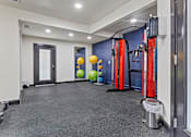 Thumbnail 10 of 45 - A gym with a variety of equipment including a squat rack, a bench, and a ball. at Tradewinds, Texas, 78239