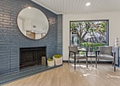 Thumbnail 5 of 45 - A living room with a fireplace and a mirror above it. at Tradewinds, Windcrest, TX