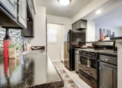 Thumbnail 46 of 50 - Spacious Kitchen with Black Appliances at The Hills at Ironhorse, Texas