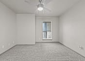 Thumbnail 39 of 43 - A room with a ceiling fan and a window with blinds.at Rock 35, Round Rock, 78681