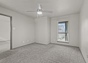 Thumbnail 41 of 43 - A room with a ceiling fan and a window with blinds.at Rock 35, Round Rock, TX, 78681
