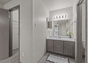 Thumbnail 34 of 43 - A bathroom with a sink, mirror, and a rug on the floor.at Rock 35, Round Rock, 78681