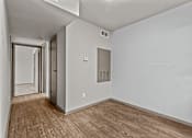 Thumbnail 21 of 43 - A long hallway with wood floors and white walls.at Rock 35, Round Rock, 78681