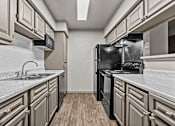 Thumbnail 31 of 43 - A kitchen with a black refrigerator and a white countertop.at Rock 35, Round Rock, TX, 78681