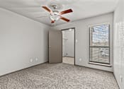 Thumbnail 24 of 43 - A room with a ceiling fan and a window with blinds.at Rock 35, Round Rock, Texas