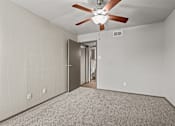 Thumbnail 19 of 43 - A room with a ceiling fan and a door.at Rock 35, Round Rock, TX, 78681