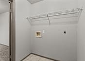 Thumbnail 30 of 43 - Empty room with a wire shelf and a door.at Rock 35, Round Rock