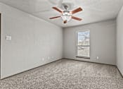 Thumbnail 20 of 43 - A room with a ceiling fan and a window with blinds.at Rock 35, Round Rock, 78681