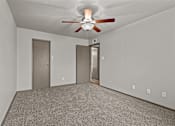 Thumbnail 27 of 43 - A room with a ceiling fan and two doors.at Rock 35, Round Rock, 78681