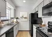 Thumbnail 18 of 45 - a kitchen with white cabinetry and black appliances at Tradewinds, Texas, 78239