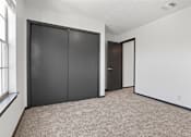 Thumbnail 23 of 45 - the living room of an apartment with two closets and two doors at Tradewinds, Windcrest, 78239