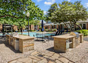 Thumbnail 6 of 29 - A pool surrounded by stone pillars and chairs.
