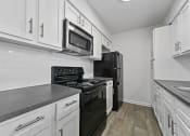 Thumbnail 54 of 58 - kitchen with white cabinets and black appliances at Vesper, Texas, 75254