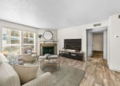 Thumbnail 25 of 58 - a living room with a wood-burning fireplace and a tv  at Vesper, Dallas, TX