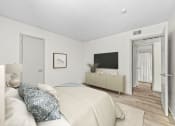 Thumbnail 38 of 58 - a bedroom with white walls and a large white bed with blue and white pillows  at Vesper, Dallas, TX, 75254