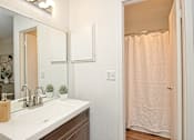 Thumbnail 14 of 15 - a bathroom with a sink and a shower and a mirror at Peaks at Northwest Hills Apartments, Austin, Texas