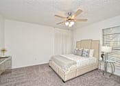 Thumbnail 13 of 15 - a bedroom with a bed and a ceiling fan at Peaks at Northwest Hills Apartments, Austin