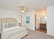 Thumbnail 12 of 15 - a bedroom with a bed and a ceiling fan at Peaks at Northwest Hills Apartments, Texas