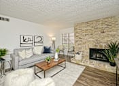 Thumbnail 11 of 15 - a living room with a couch and a fireplace at Peaks at Northwest Hills Apartments, Austin, 78731